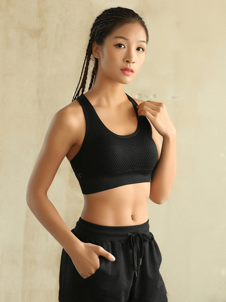 Woman wearing a black Stylish Elastic Breathable Open Back Push Up Sports Bra, ideal for yoga and workouts, offering comfort and support.